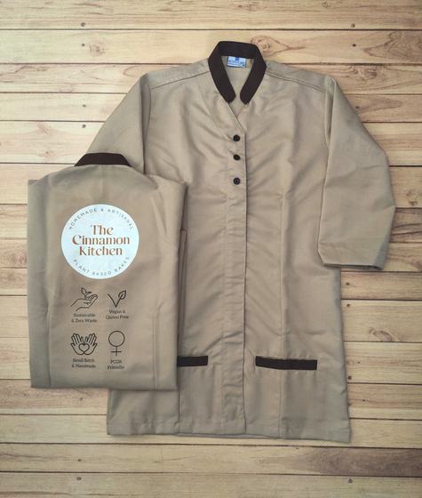 Beige tunic with brown collar and pocket trim, dark buttons and beige tote bag with round printed logo, custom made by RestroCart, New Delhi