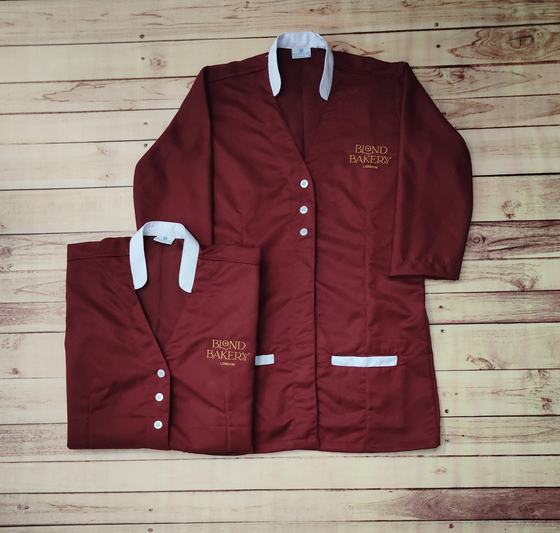 Maroon long tunics with white collar and pocket trim, white buttons and gold embroidered logo, custom made by RestroCart, New Delhi