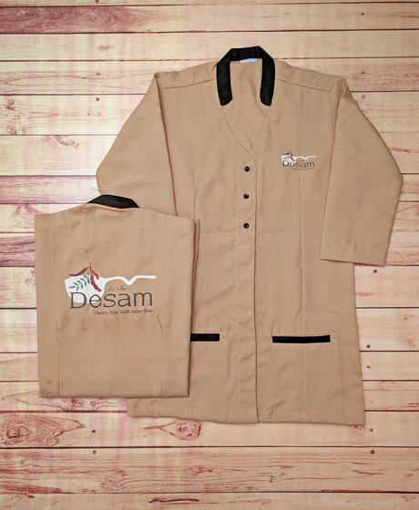 Beige long tunics with black collar and pocket trim, folded one showing red and grey leaf back print, custom made by RestroCart, New Delhi