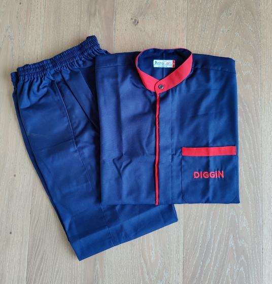 Navy housekeeping tunic with red collar, red placket piping and embroidered pocket name, with navy trousers, custom made for Diggin by RestroCart, New Delhi