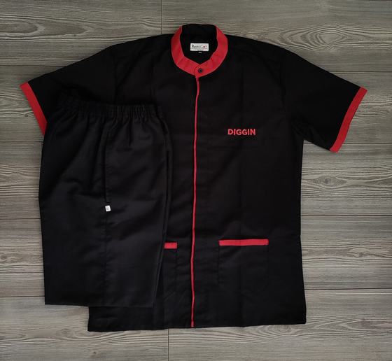 Black housekeeping tunic with red collar, piping and pocket trims and red logo, with black trousers, custom made for Diggin by RestroCart, New Delhi