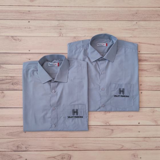 Two grey full sleeve shirts with embroidered logo and Valet Parking text on pocket, folded, custom made for Housewood Villas by RestroCart, New Delhi