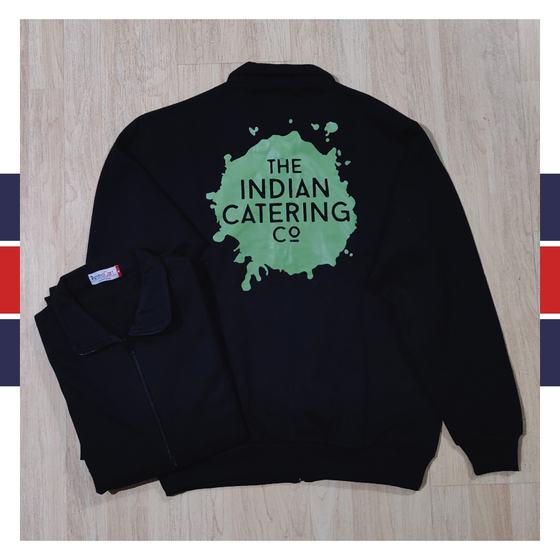 Black zip jacket with large green splash logo printed on back, front shown folded, custom made for Indian Catering Company by RestroCart, New Delhi