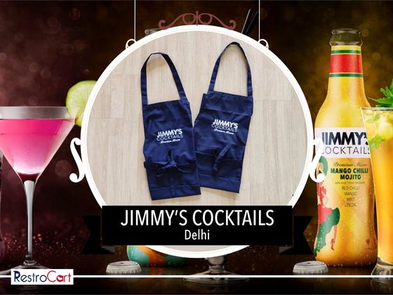 Two navy bib aprons with white printed logo and front pockets, laid flat side by side, custom made for Jimmy's Cocktails by RestroCart, New Delhi