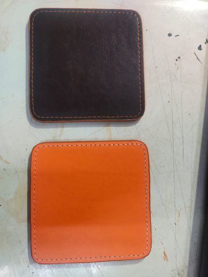 Plain square leatherette coasters in dark brown and orange with contrast edge stitching, custom made by RestroCart, New Delhi