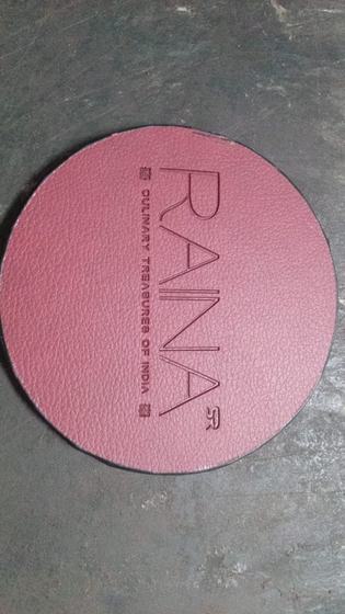 Round plum leatherette coaster with debossed vertical wordmark and tagline, custom made by RestroCart, New Delhi