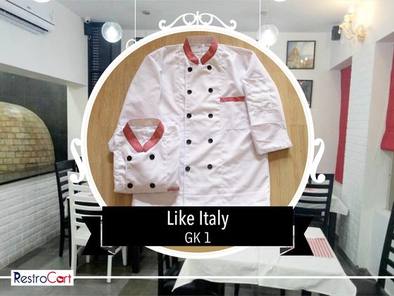 White chef coats with red collar and black double-breasted buttons, one folded, custom made for Like Italy by RestroCart, New Delhi