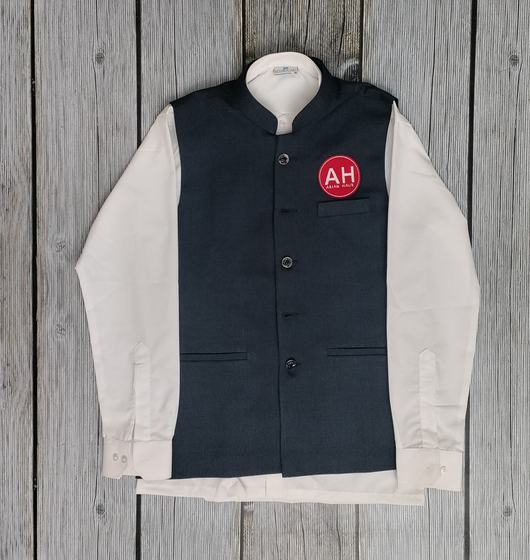 Charcoal bandhgala style waistcoat with red round logo badge over a long-sleeve cream shirt, custom made by RestroCart, New Delhi