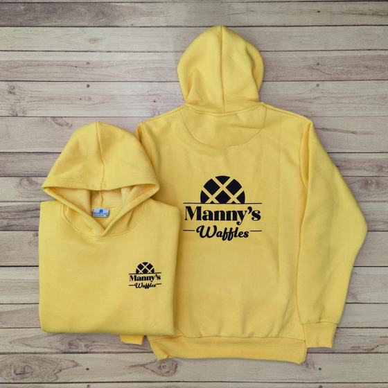 Two yellow hoodies with black printed logo on back and small chest logo, one folded, custom made for Manny's Waffles by RestroCart, New Delhi