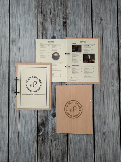 Light wood MDF ring-bound coffee menu with engraved round logo cover and printed inner pages, custom made by RestroCart, New Delhi