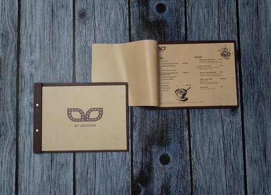 Landscape MDF menu board with kraft printed cover and mask logo, beside an open kraft menu, custom made by RestroCart, New Delhi