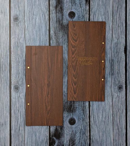 Tall dark wood MDF menu boards with brass screw posts and gold engraved script logo, custom made by RestroCart, New Delhi