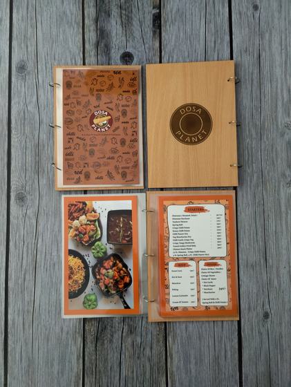 Light wood ring bound menu with printed orange illustrated cover and photo food pages, open and closed, custom made by RestroCart, New Delhi
