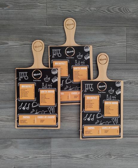 Three MDF paddle menu boards with engraved logo and black and orange chalkboard style menus, custom made by RestroCart, New Delhi