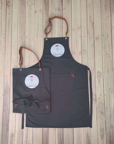 Charcoal canvas apron pair with tan leather straps and round white printed logo, custom made by RestroCart, New Delhi