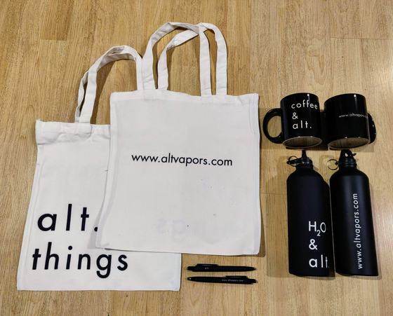 Merchandise kit of two canvas tote bags, black mugs, black steel bottles and pens, custom made by RestroCart, New Delhi