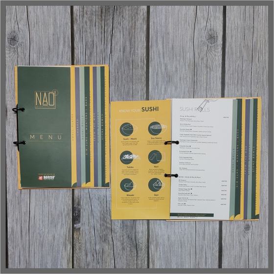Green ring bound menu cover with gold logo and open printed menu pages with sushi icons, custom made for NAO by RestroCart, New Delhi