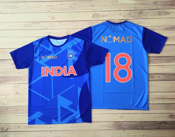 Blue cricket style sublimated jerseys, front with text and back with number 18, custom made for NOMAD Pizza by RestroCart, New Delhi