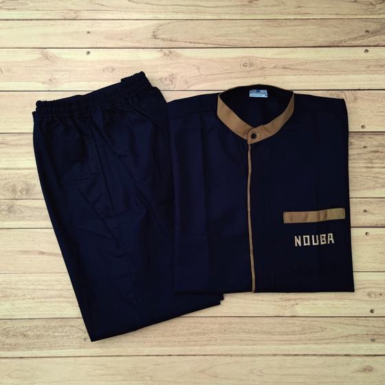 Navy housekeeping tunic with tan collar and pocket trim, matching navy trousers, laid flat, custom made for Nouba by RestroCart, New Delhi