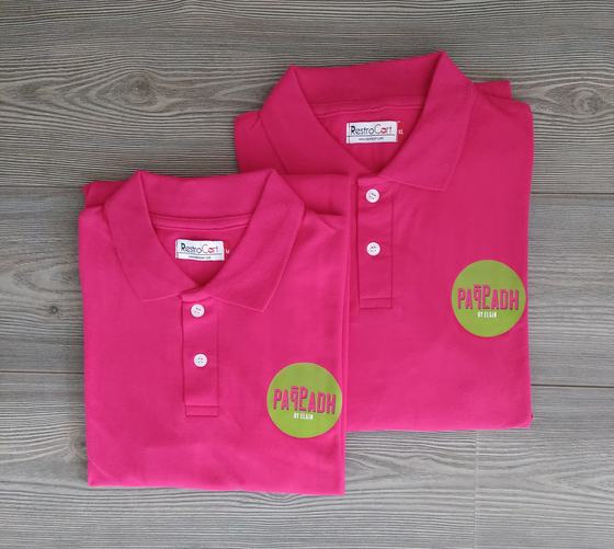 Hot pink polo t-shirts with round lime green printed chest logo, folded pair, custom made for Pappadh by RestroCart, New Delhi