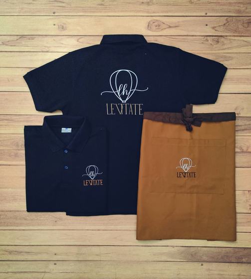 Navy polo t-shirts with white hot air balloon logo and tan waist apron with matching embroidery, custom made by RestroCart, New Delhi