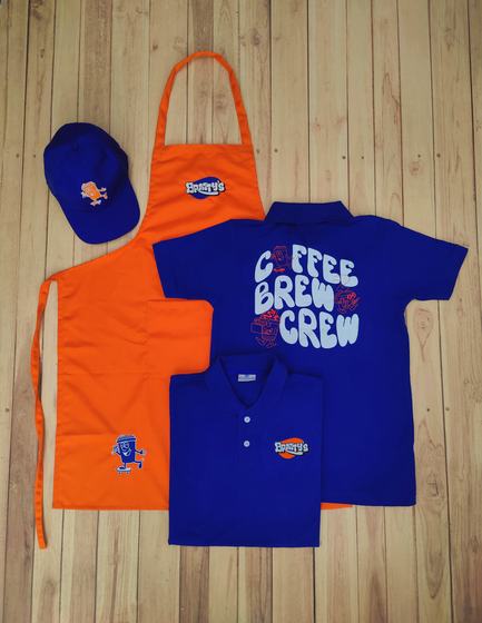 Royal blue polo t-shirts with back print, orange bib apron and blue cap with cartoon logos, custom made by RestroCart, New Delhi
