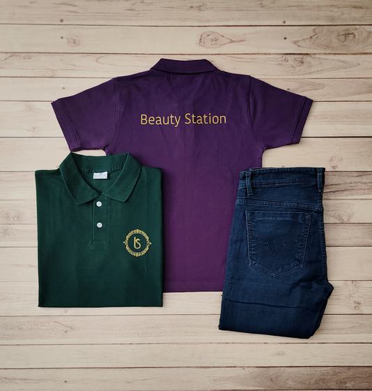 Purple and bottle green polo t-shirts with gold text and round crest logo, with blue denim jeans, custom made by RestroCart, New Delhi