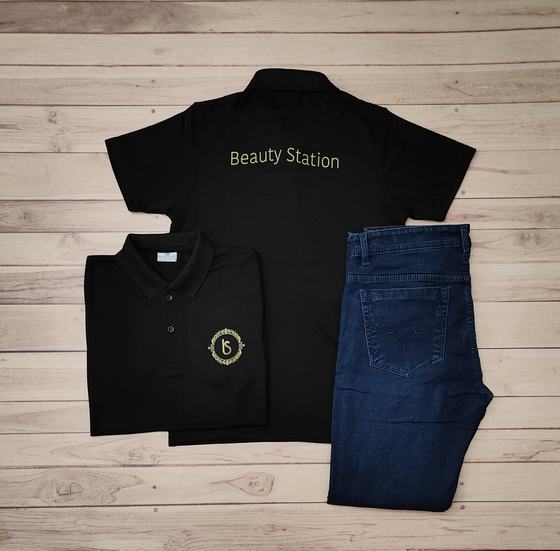 Black polo t-shirts with gold back text and round gold crest logo, paired with blue denim jeans, custom made by RestroCart, New Delhi