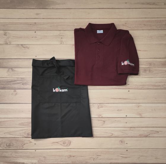 Maroon polo t-shirt with sleeve logo and black waist apron with white and red printed logo, custom made by RestroCart, New Delhi