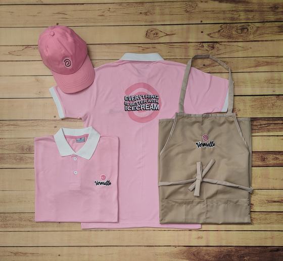 Pink polo t-shirts with white collar and back print, pink cap and khaki bib apron with logo, custom made by RestroCart, New Delhi