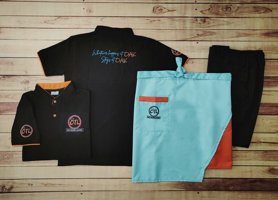 Black polo t-shirts with orange trim and blue script, aqua waist apron and black trousers, custom made by RestroCart, New Delhi