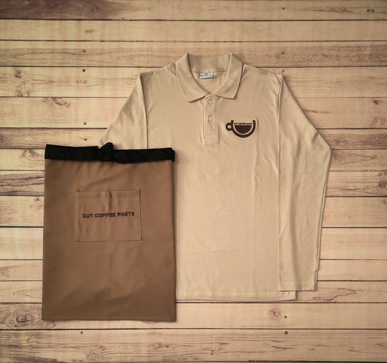 Beige full sleeve polo t-shirt with brown cup logo and brown waist apron with pocket print, custom made by RestroCart, New Delhi