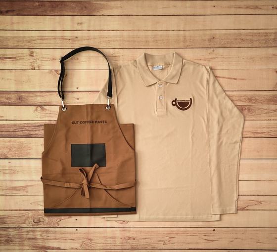 Beige full sleeve polo t-shirt with brown cup logo and brown canvas bib apron with leather straps, custom made by RestroCart, New Delhi