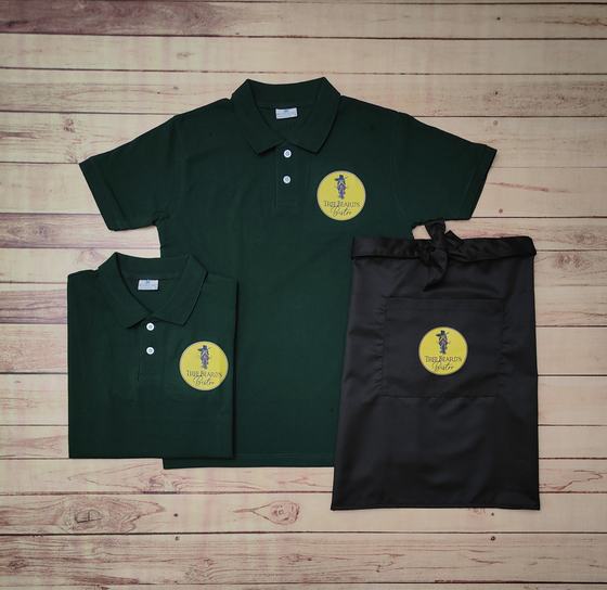Bottle green polo t-shirts with yellow round badge logo and black waist apron with same badge, custom made by RestroCart, New Delhi
