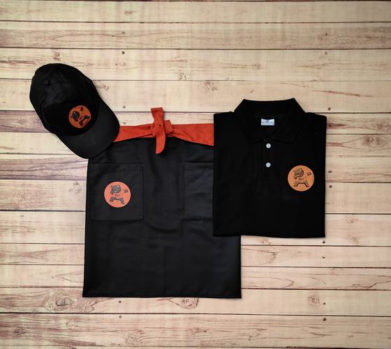 Black polo t-shirt with orange round logo, black waist apron with orange ties and black cap, custom made by RestroCart, New Delhi