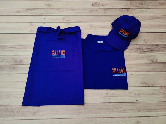Royal blue service set of waist apron, polo t-shirt and baseball cap with orange printed wordmark, custom made by RestroCart, New Delhi