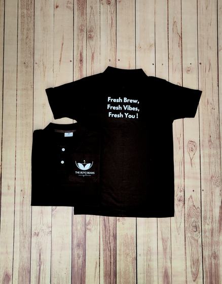 Black polo t-shirts with white printed slogan on the back and swan logo on the front, custom made by RestroCart, New Delhi