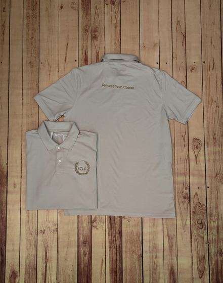 Light grey polo t-shirts with brown wreath chest logo and printed slogan across the back, custom made by RestroCart, New Delhi