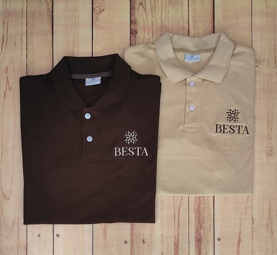 Dark brown and beige polo t-shirts with embroidered snowflake-style logo, folded side by side, custom made by RestroCart, New Delhi