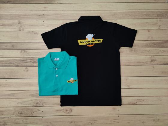 Black polo t-shirt with yellow and orange printed back logo and folded teal polo with chest logo, custom made by RestroCart, New Delhi