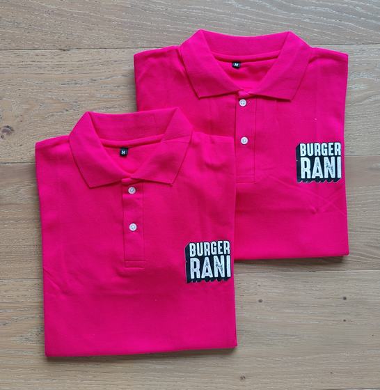 Two hot pink polo t-shirts with black and white printed logo patch, folded, custom made by RestroCart, New Delhi