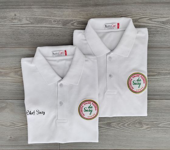 Two white polo t-shirts with round green and red embroidered badge logo and script name, custom made by RestroCart, New Delhi