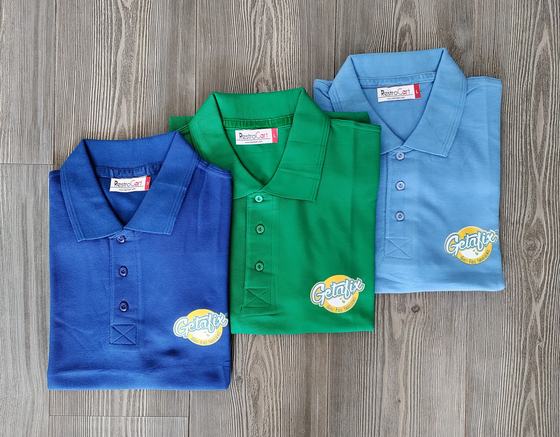Three polo t-shirts in royal blue, green and sky blue with yellow printed round logo, custom made for Getafix by RestroCart, New Delhi