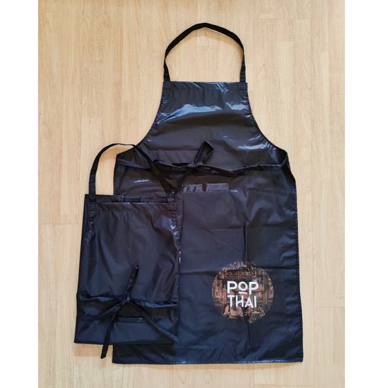 Two navy satin finish bib aprons with printed square logo on corner, adult and small size, custom made for Pop Thai by RestroCart, New Delhi