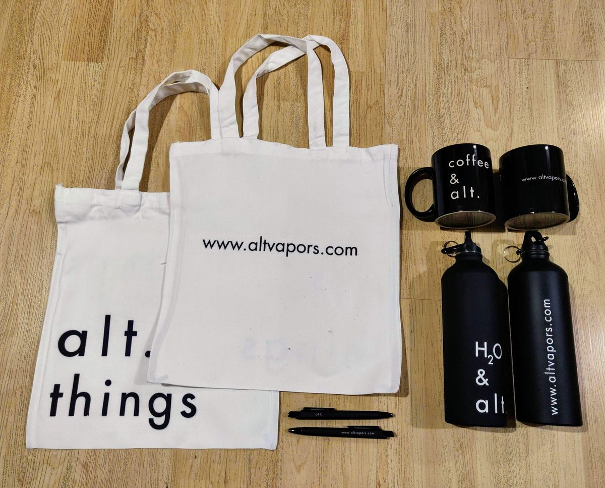 Printed tote bags and black bottles merchandise