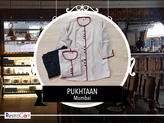 Beige tunic with red piping and black buttons, a smaller matching top and black trousers, custom made for Pukhtaan by RestroCart, New Delhi