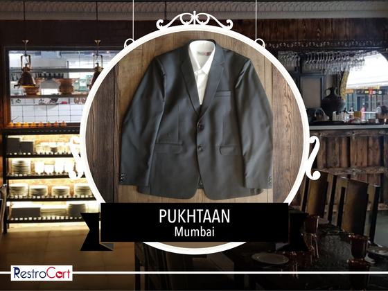 Charcoal grey single-breasted blazer over a white shirt, laid flat on a wooden board, custom made for Pukhtaan by RestroCart, New Delhi