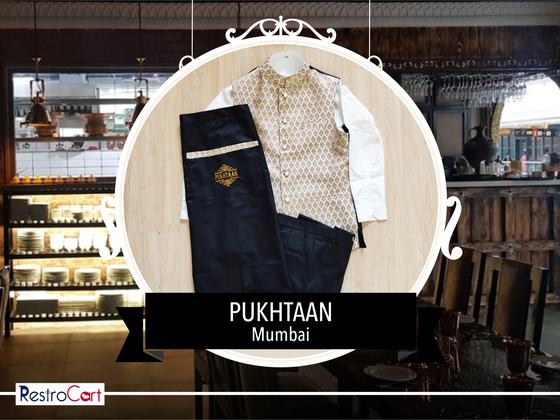 Gold patterned Nehru waistcoat over a white kurta with black trousers and logo detail, custom made for Pukhtaan by RestroCart, New Delhi