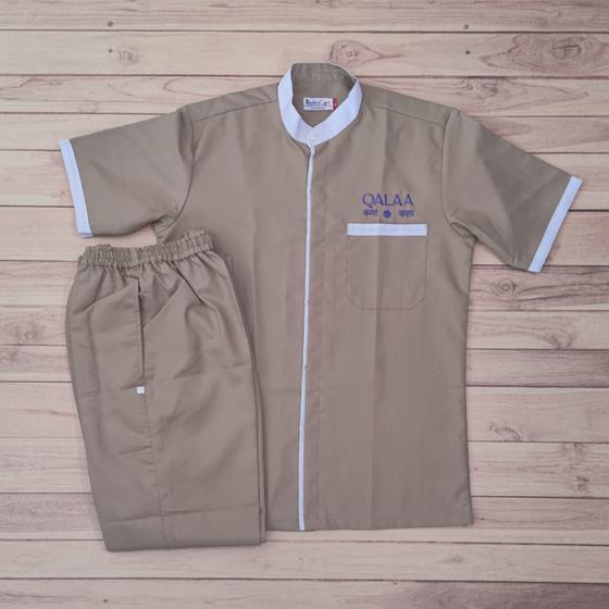 Beige half sleeve housekeeping tunic with white collar and trim, matching trousers and purple logo, custom made for Qalaa by RestroCart, New Delhi