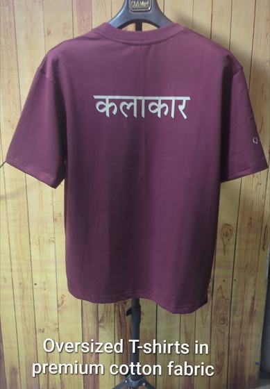 Maroon oversized cotton t-shirt on hanger with white Hindi word printed on back, custom made for Qalaa by RestroCart, New Delhi